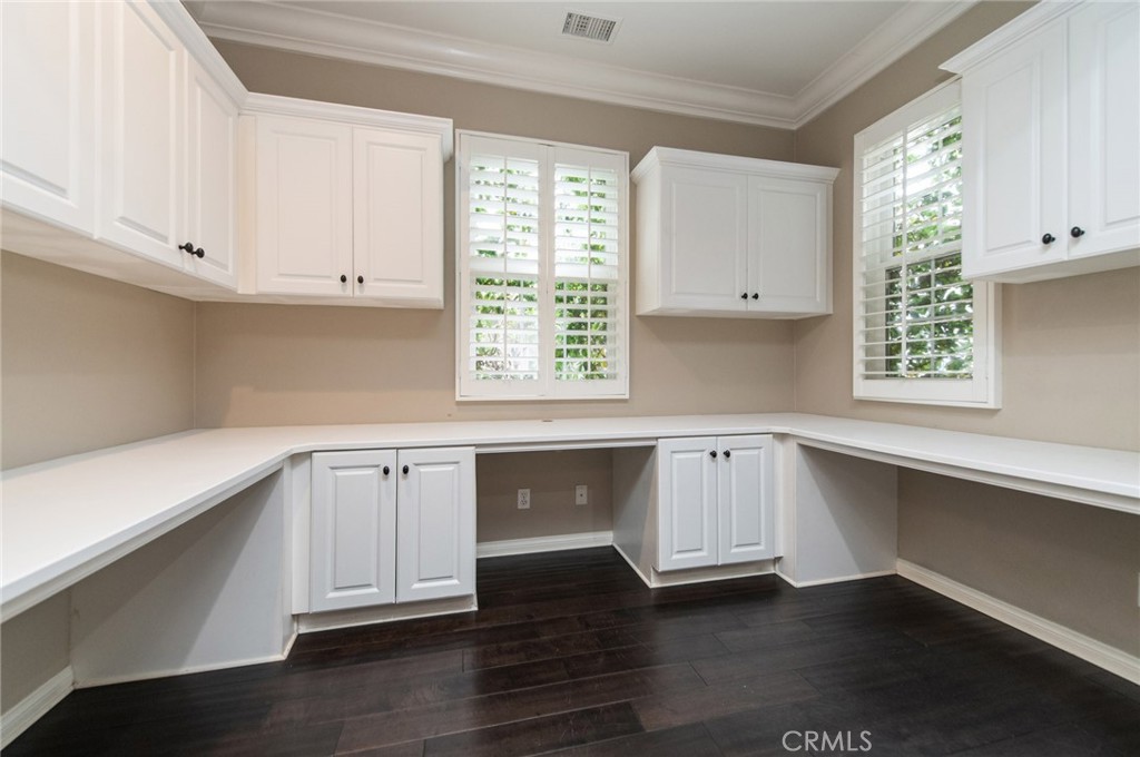26 Secret Garden Irvine, CA 92620 - Photo 32 of 38 a kitchen with wooden floors white cabinets and a window