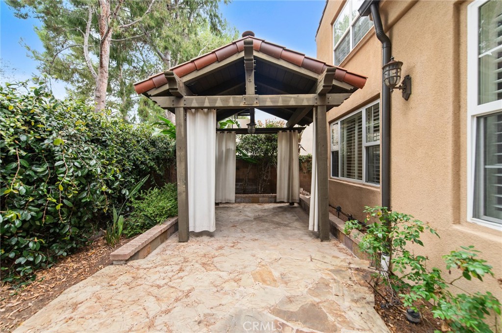 26 Secret Garden Irvine, CA 92620 - Photo 36 of 38 a view of a wooden house with a yard and potted plants