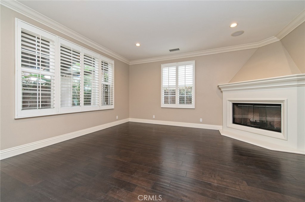 26 Secret Garden Irvine, CA 92620 - Photo 4 of 38 a view of an empty room with wooden floor and a window