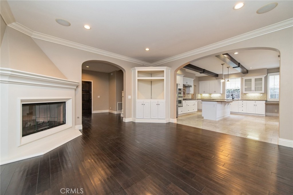 26 Secret Garden Irvine, CA 92620 - Photo 6 of 38 a view of a hallway with wooden floor and a fireplace