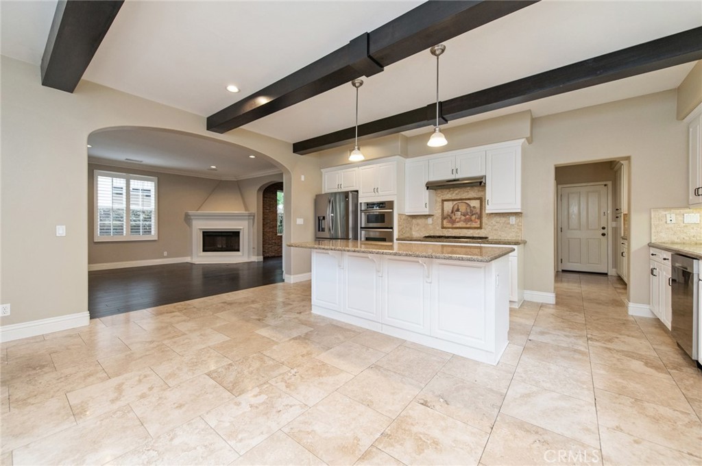 26 Secret Garden Irvine, CA 92620 - Photo 7 of 38 a large kitchen with kitchen island a sink stainless steel appliances and cabinets