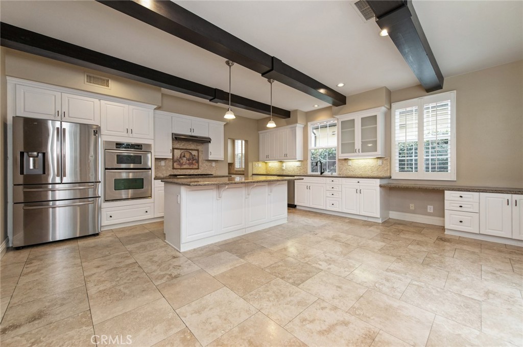 26 Secret Garden Irvine, CA 92620 - Photo 8 of 38 a large kitchen with stainless steel appliances granite countertop a stove refrigerator and cabinets