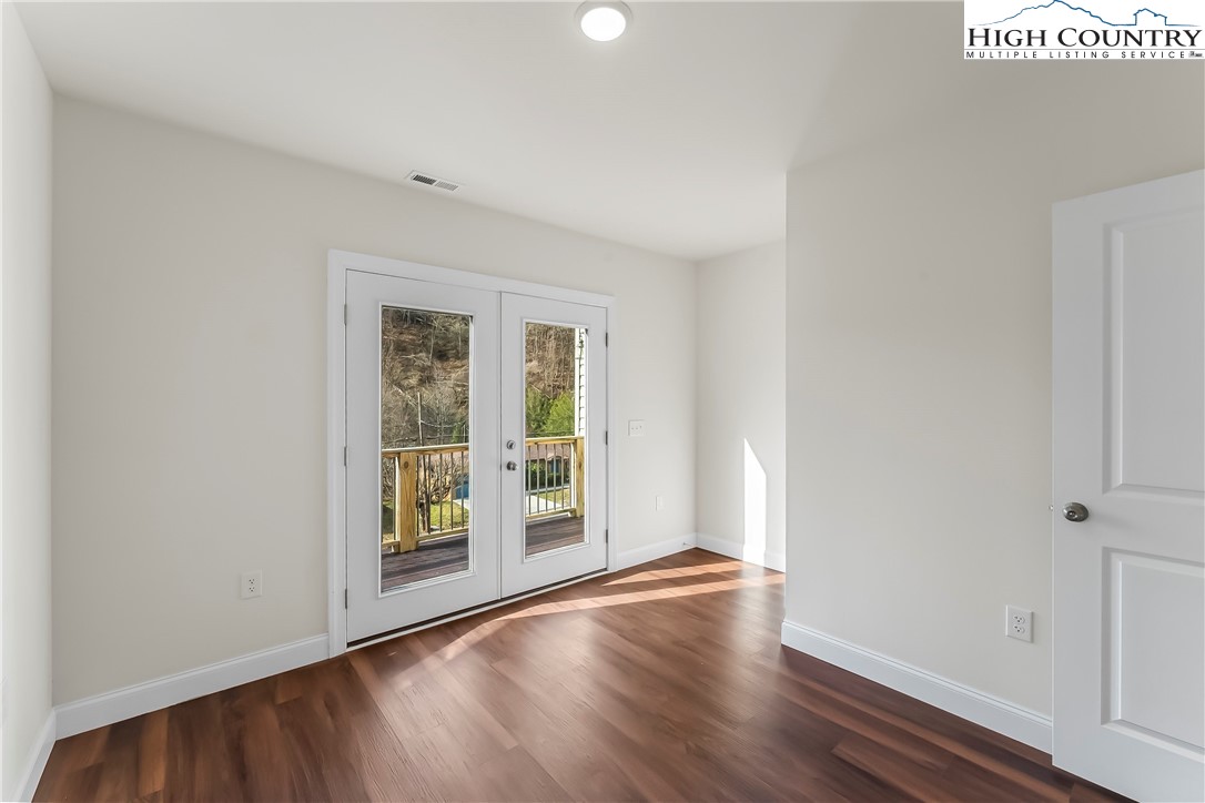 262 Old Bristol Road Boone, NC 28607 - Photo 21 of 38 an empty room with wooden floor and windows
