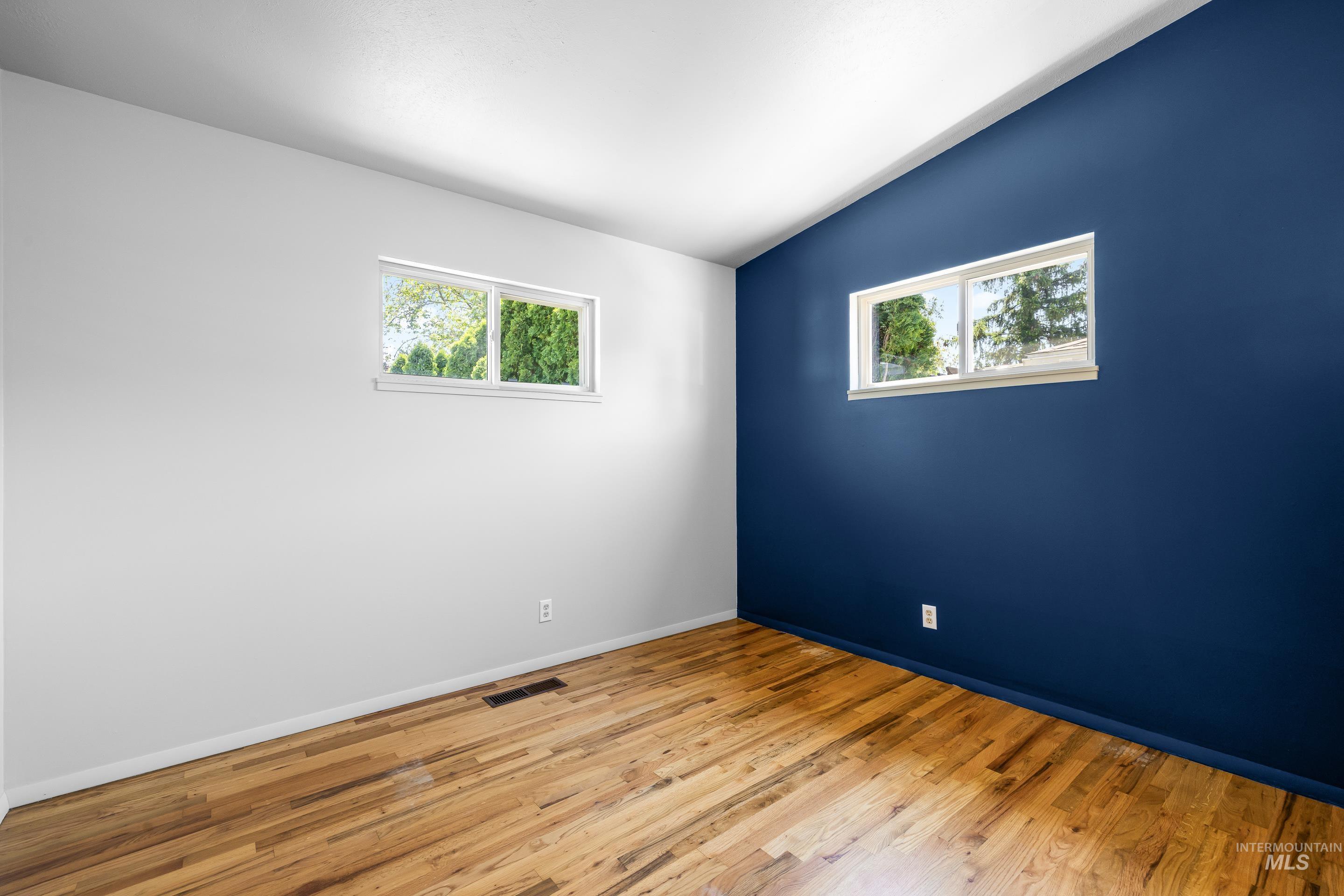 708 South Phillippi Street Boise, ID 83705 - Photo 13 of 25 Room featuring varied wall colors, including a deep blue accent wall