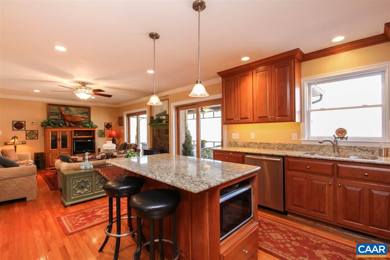 52 Oak Grove Road Palmyra, VA 22963 - Photo 1 of 46 a open kitchen with stainless steel appliances granite countertop a kitchen island a stove a sink dishwasher and cabinets with wooden floor