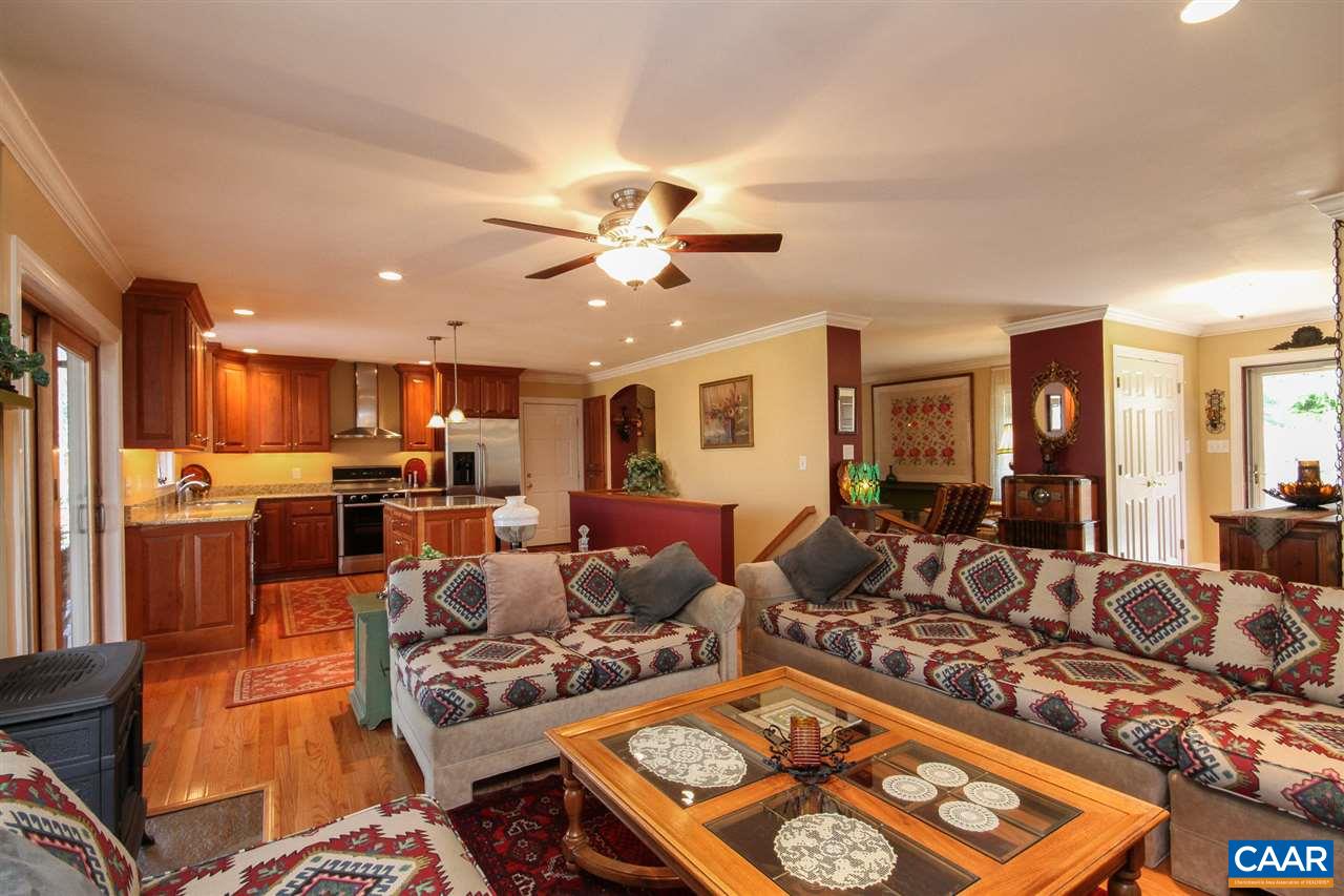 52 Oak Grove Road Palmyra, VA 22963 - Photo 5 of 46 a living room with furniture kitchen view and a chandelier
