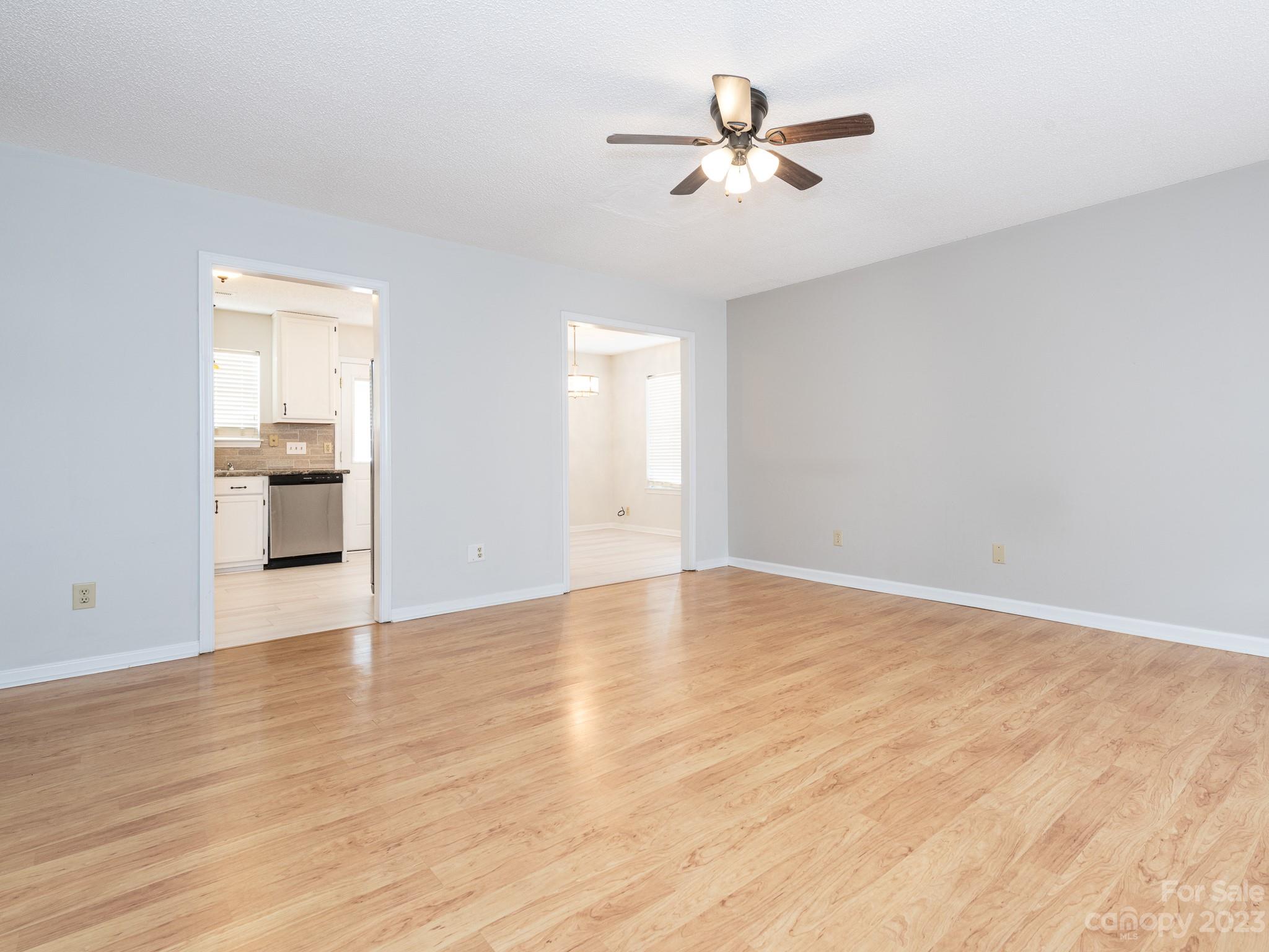 1007 Ridgefield Circle Indian Trail, NC 28079 - Photo 4 of 35 an empty room with wooden floor and windows