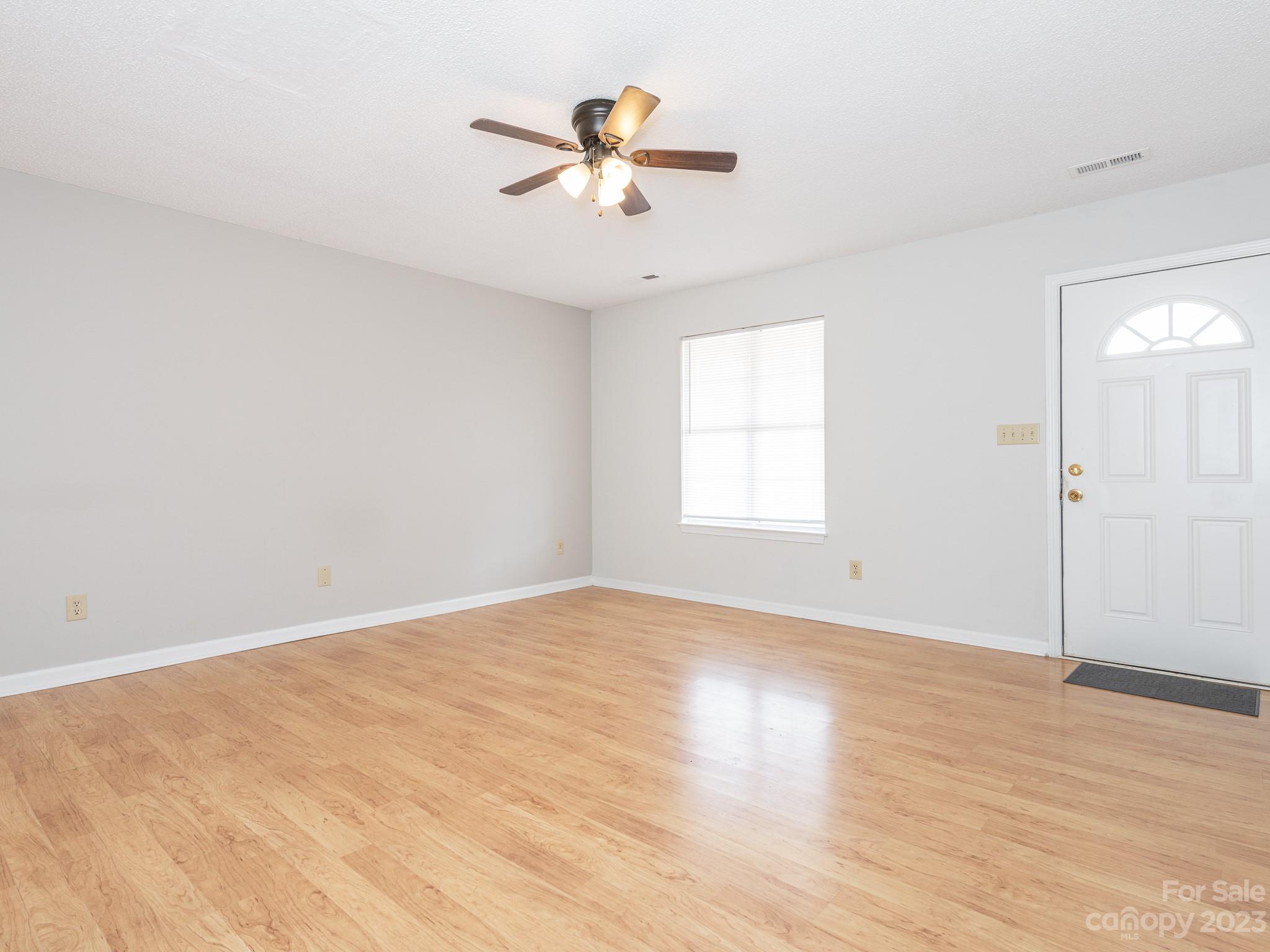1007 Ridgefield Circle Indian Trail, NC 28079 - Photo 6 of 35 wooden floor in an empty room with a window