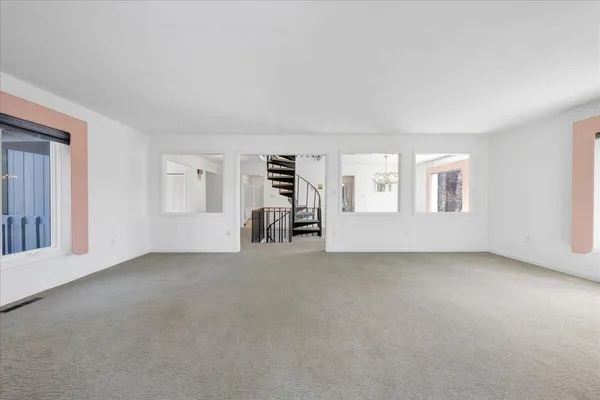 a view of a livingroom with an empty space and a window