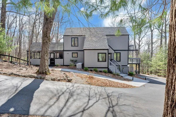 a view of a house with a yard covered with snow