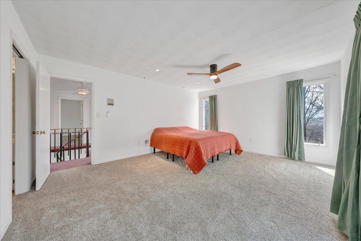 6878 Mt Chestnut Road Roanoke, VA 24018 - Photo 26 of 50 a bedroom with a bed and a chandelier