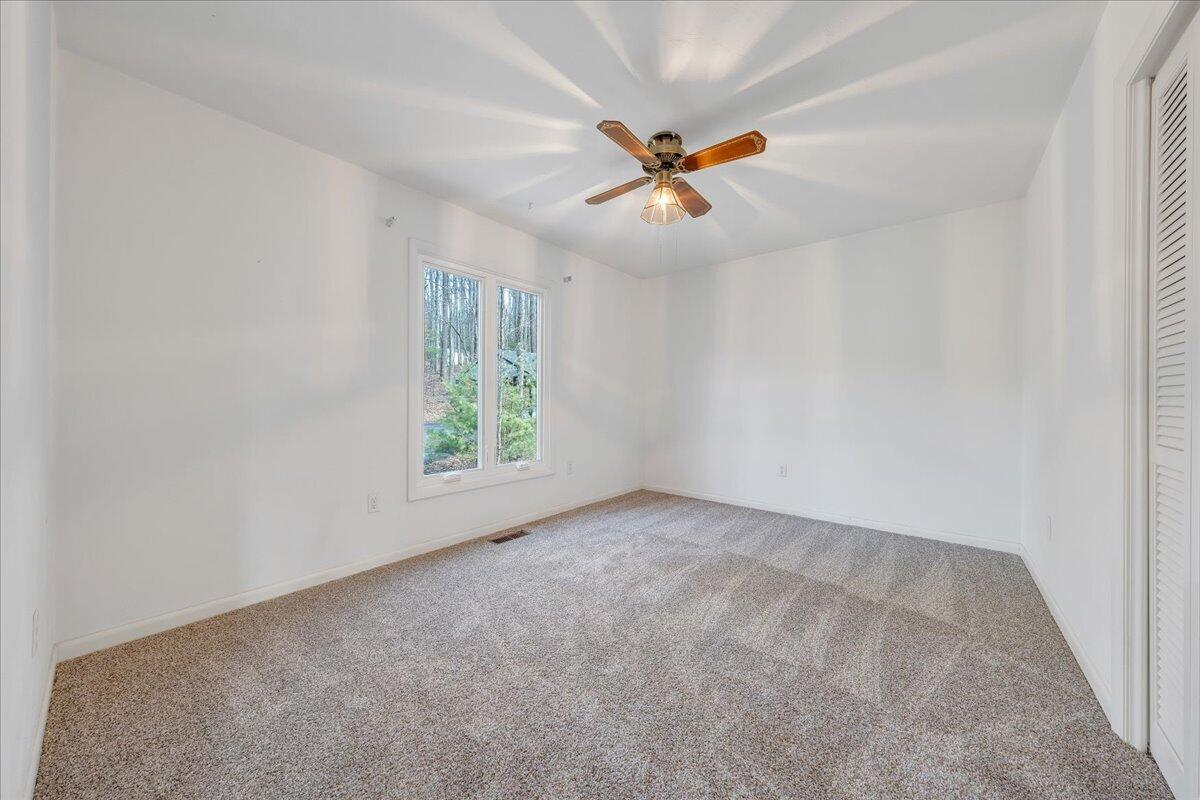 6878 Mt Chestnut Road Roanoke, VA 24018 - Photo 29 of 50 an empty room with windows and fan