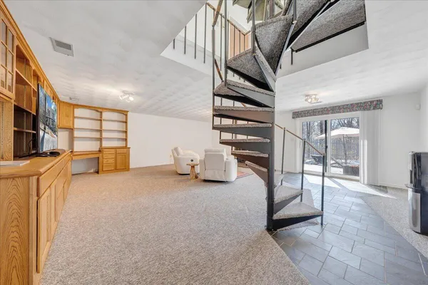 a room with gym equipment and a rug