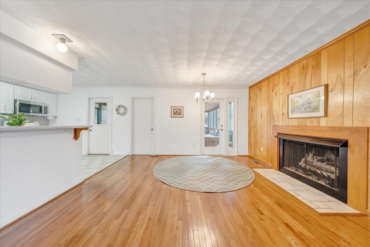 6878 Mt Chestnut Road Roanoke, VA 24018 - Photo 4 of 50 a view of empty room with wooden floor and fireplace