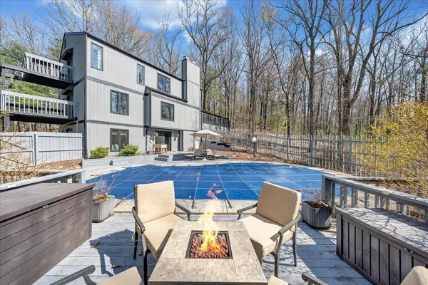 a balcony with wooden floor and outdoor seating