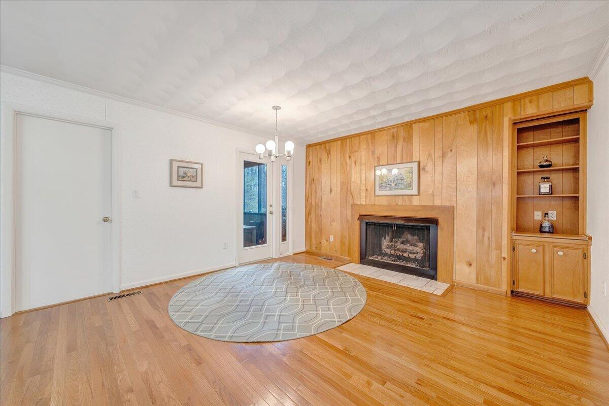 6878 Mt Chestnut Road Roanoke, VA 24018 - Photo 5 of 50 an empty room with windows a fireplace and wooden floor