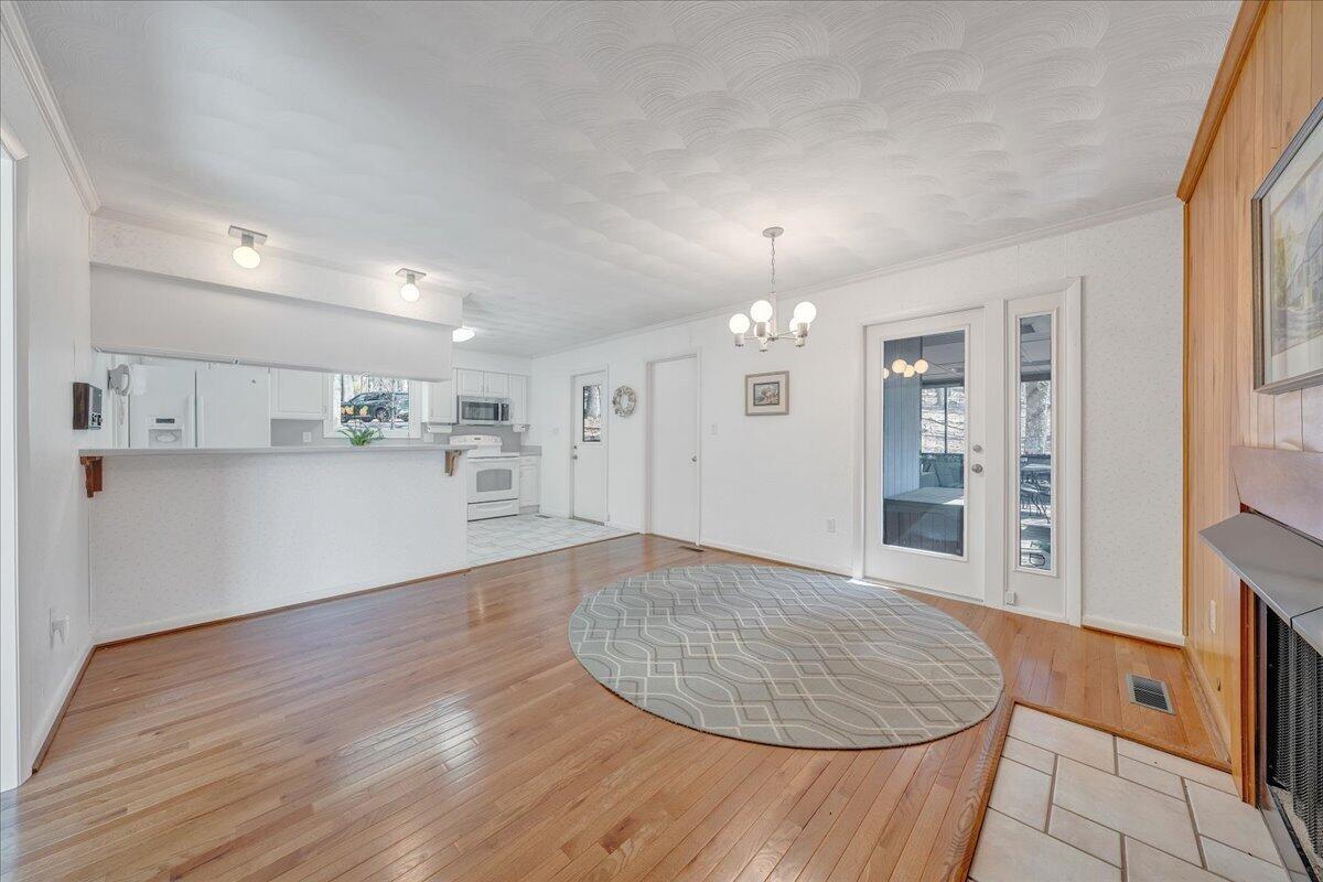 6878 Mt Chestnut Road Roanoke, VA 24018 - Photo 6 of 50 a view of kitchen and empty room with wooden floor