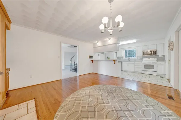 a view of a kitchen with a refrigerator cabinets and wooden floor