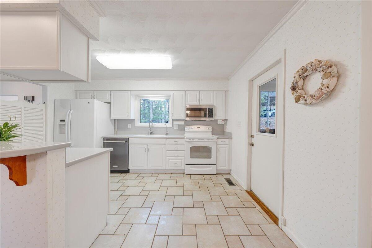 6878 Mt Chestnut Road Roanoke, VA 24018 - Photo 8 of 50 a kitchen with white cabinets and window