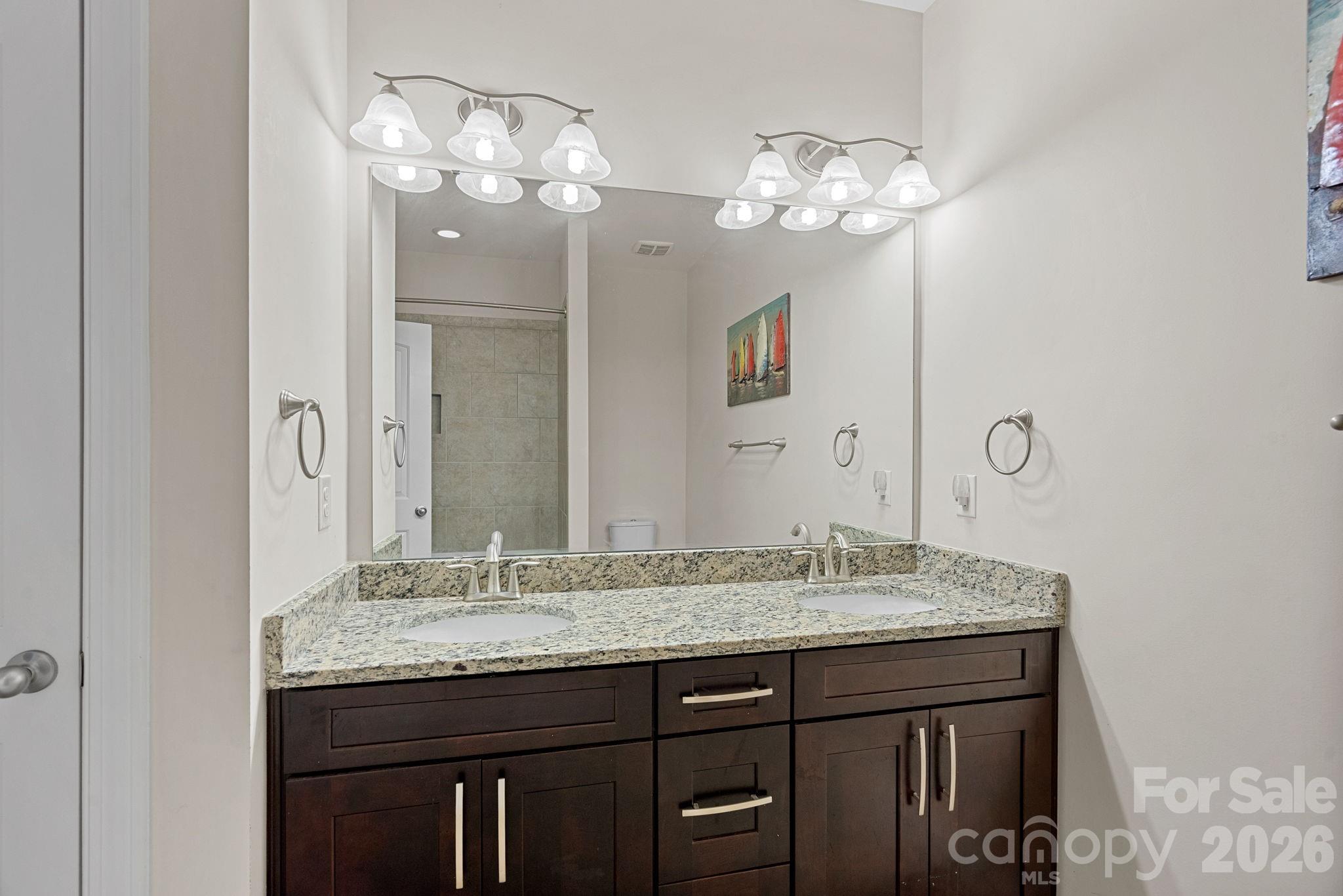 897 Tyne Drive Fort Mill, SC 29715 - Photo 16 of 46 a bathroom with a granite countertop sink a large mirror and a shower