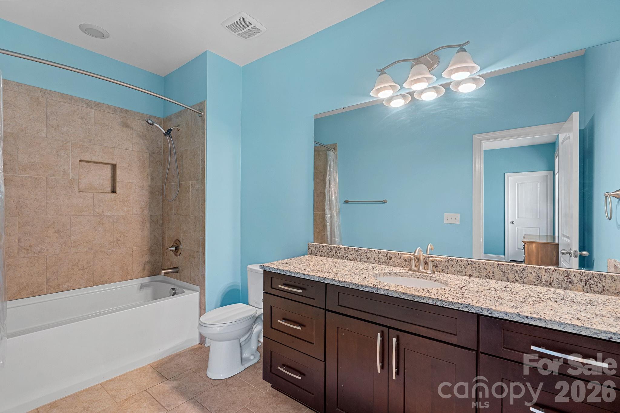 897 Tyne Drive Fort Mill, SC 29715 - Photo 18 of 46 a bathroom with a granite countertop sink a toilet and shower