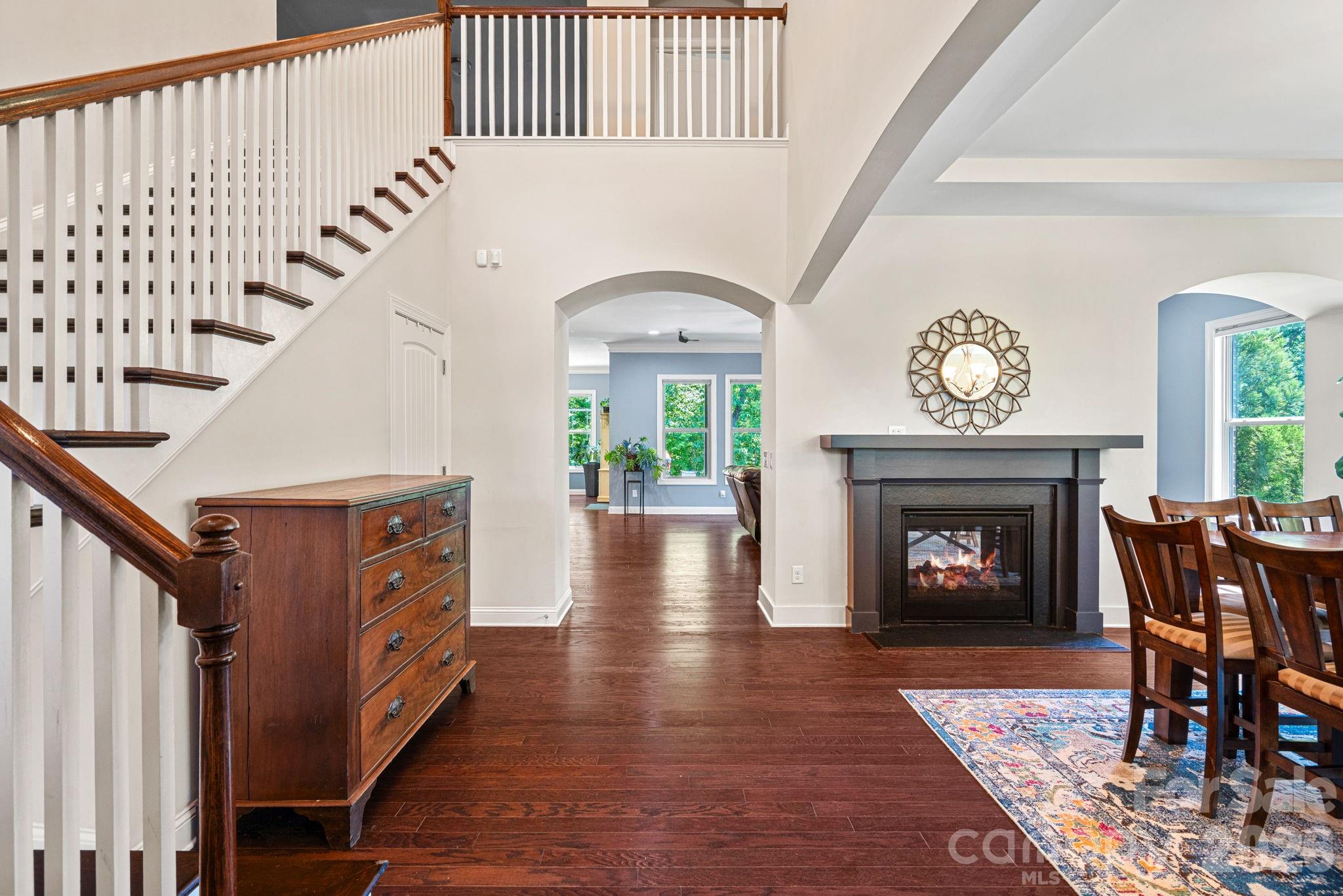 897 Tyne Drive Fort Mill, SC 29715 - Photo 2 of 46 a view of an entryway with wooden floor a fireplace and a chandelier