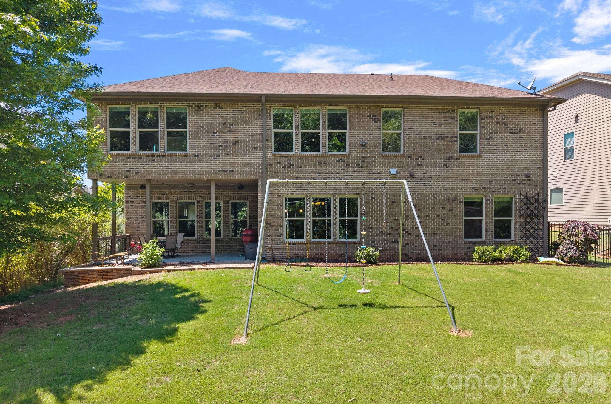 897 Tyne Drive Fort Mill, SC 29715 - Photo 22 of 46 a view of a brick house with a yard in front of it