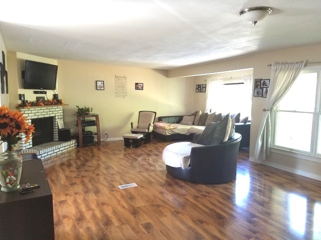 723 Town Road West Chicago, IL 60185 - Photo 4 of 17 a living room with furniture a flat screen tv and a window