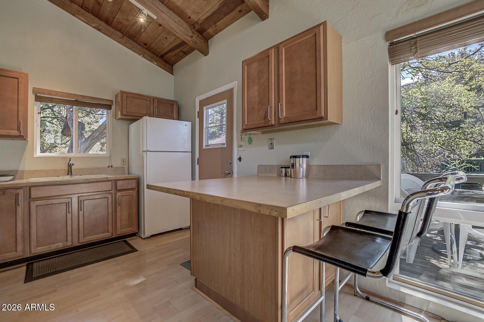 4880 Tor Street Pine, AZ 85544 - Photo 12 of 34 a kitchen that has a sink a stove and a refrigerator
