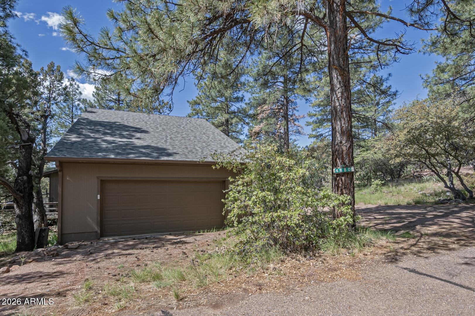 4880 Tor Street Pine, AZ 85544 - Photo 18 of 34 a front view of a house with a yard and garage