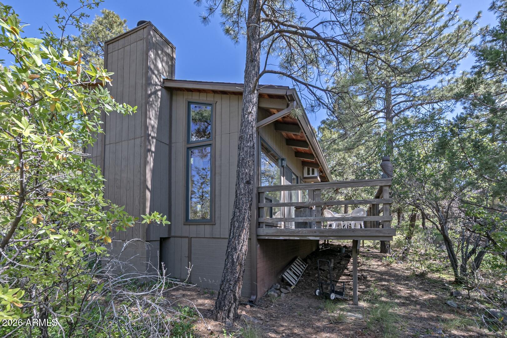4880 Tor Street Pine, AZ 85544 - Photo 31 of 34 a view of a house with a tree and wooden fence