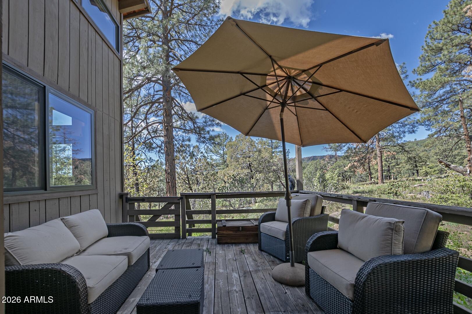4880 Tor Street Pine, AZ 85544 - Photo 4 of 34 a balcony with furniture and umbrella