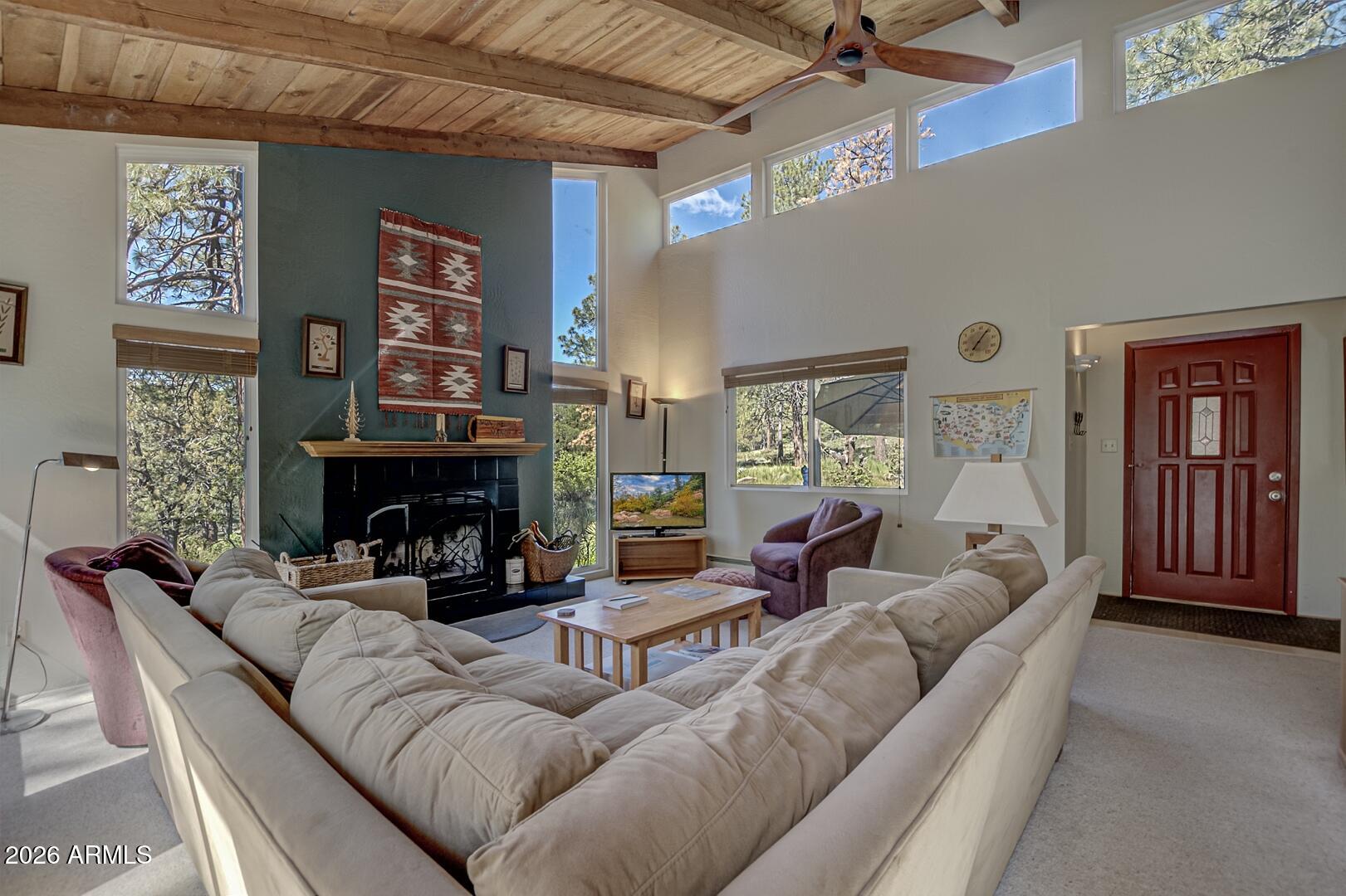 4880 Tor Street Pine, AZ 85544 - Photo 7 of 34 a living room with furniture a fireplace and a large window