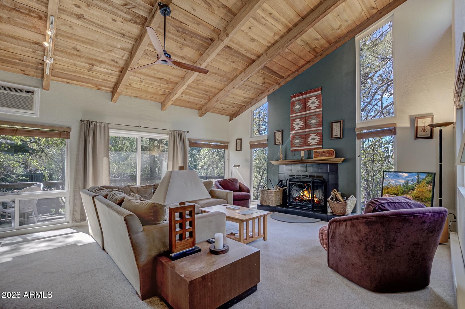 4880 Tor Street Pine, AZ 85544 - Photo 9 of 34 a living room with furniture fireplace and a floor to ceiling window