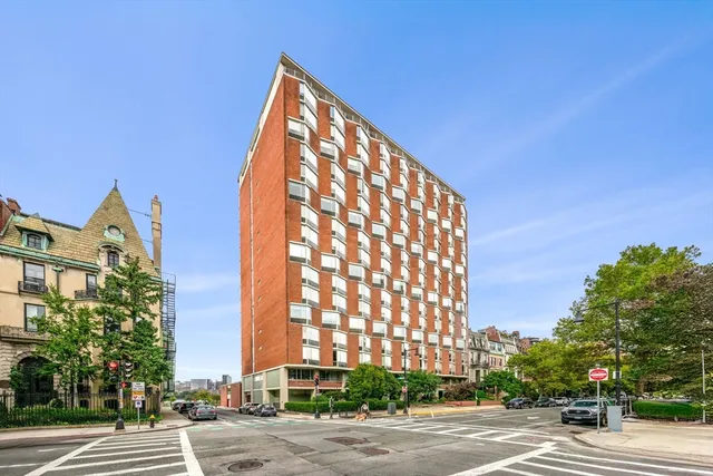 a view of a tall building next to a road