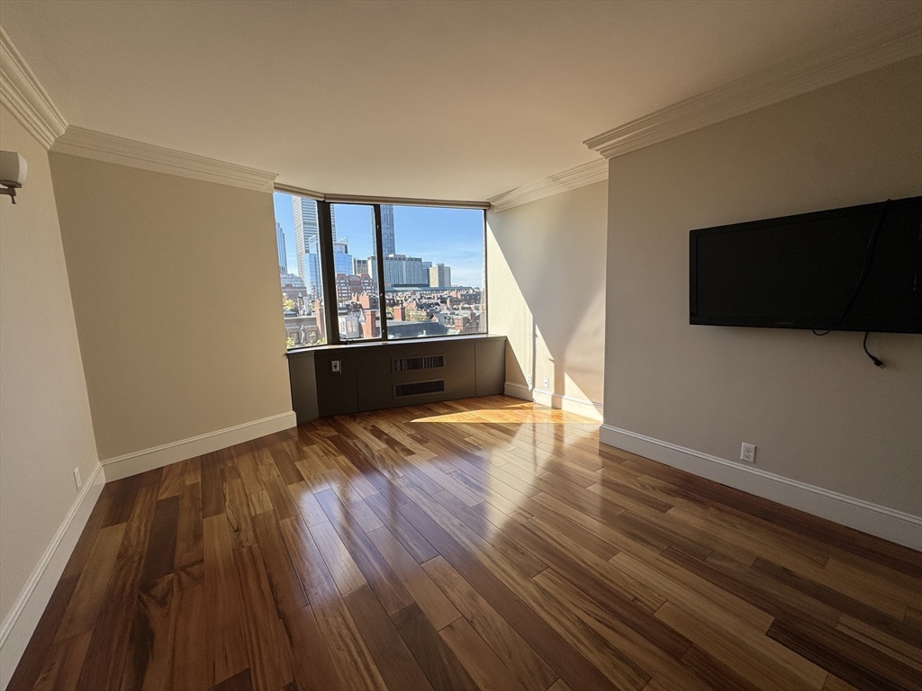 330 Beacon Street, Unit 85 Boston, MA 02116 - Photo 11 of 16 a view of empty room with wooden floor and fan