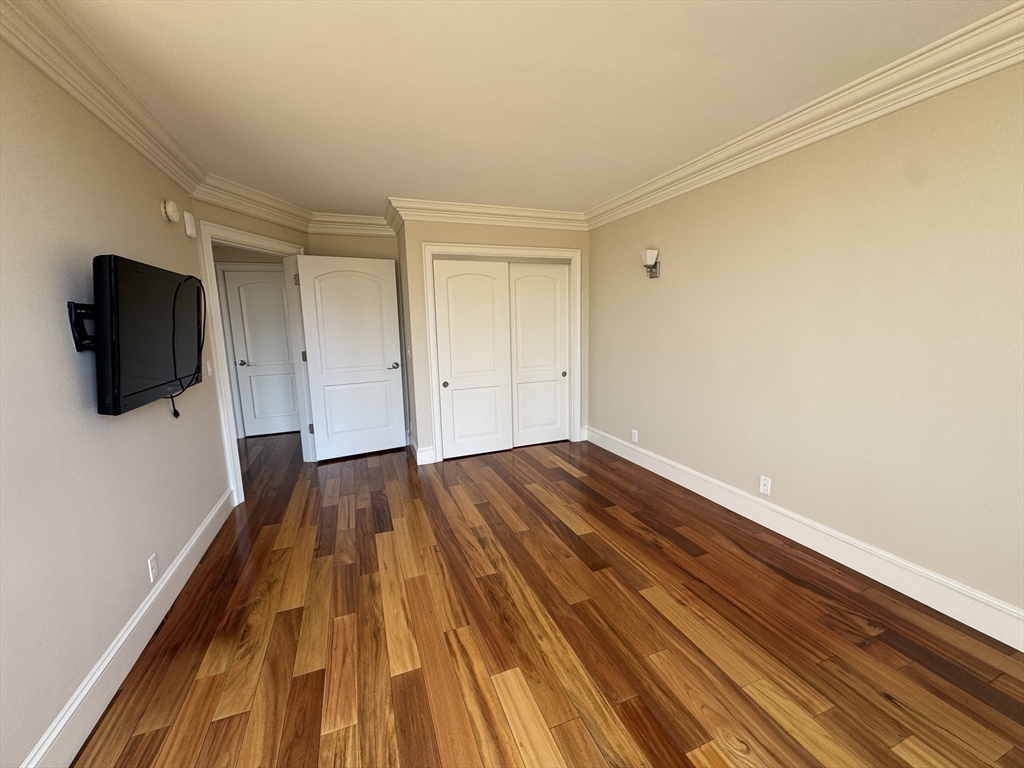 330 Beacon Street, Unit 85 Boston, MA 02116 - Photo 12 of 16 a view of a room with wooden floor and tv