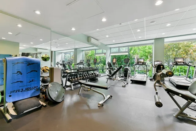 a room with gym equipment and a large window