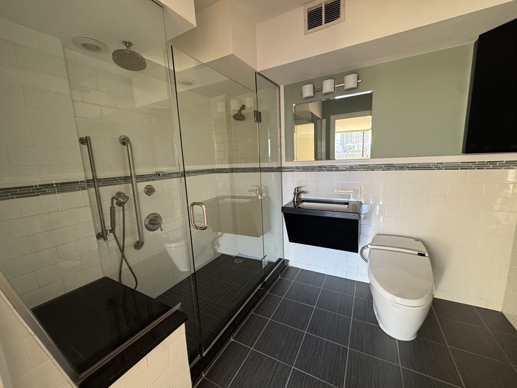 330 Beacon Street, Unit 85 Boston, MA 02116 - Photo 9 of 16 a bathroom with a sink a toilet a mirror and shower