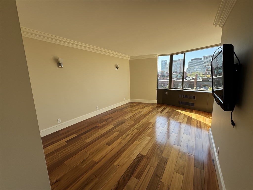 330 Beacon Street, Unit 85 Boston, MA 02116 - Photo 10 of 16 a view of a room with wooden floor and a window