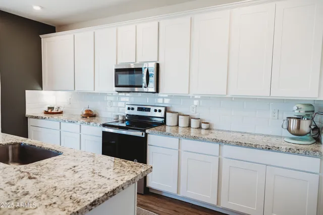 a view of bedroom with baby crib and closet