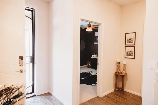 a view of a livingroom with wooden floor and bedroom view