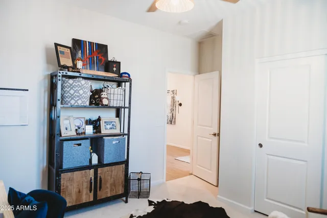 a bedroom with a bed and a refrigerator