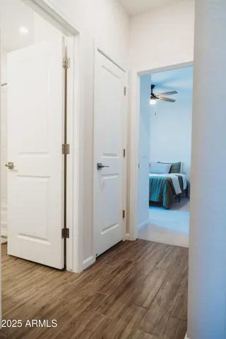 a view of a hallway with wooden floor and entryway