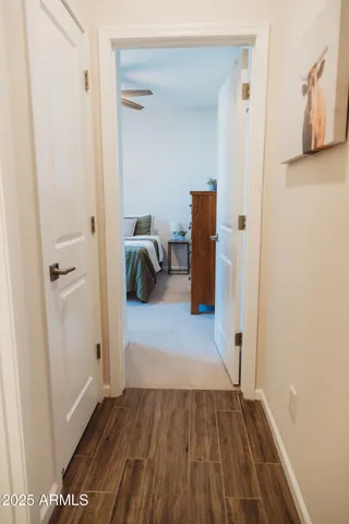 a view of a hallway with wooden floor and staircase
