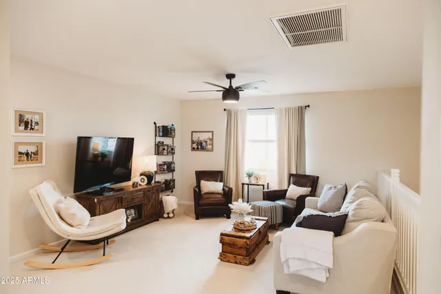 a bedroom with a refrigerator and a flat screen tv