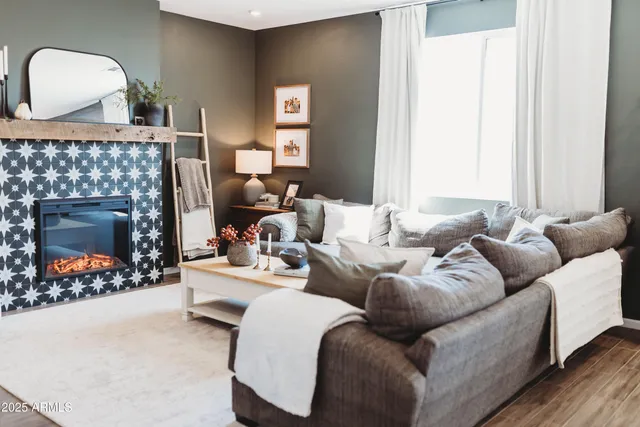 a living room with furniture and a wooden floor