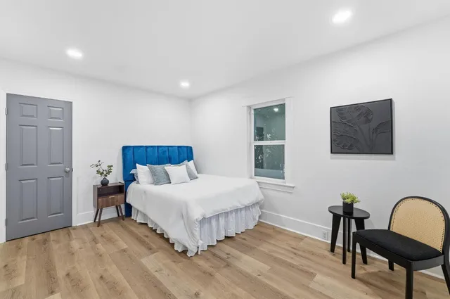 a bedroom with a bed and a desk