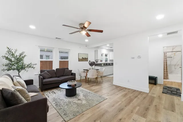 a living room with furniture and wooden floor