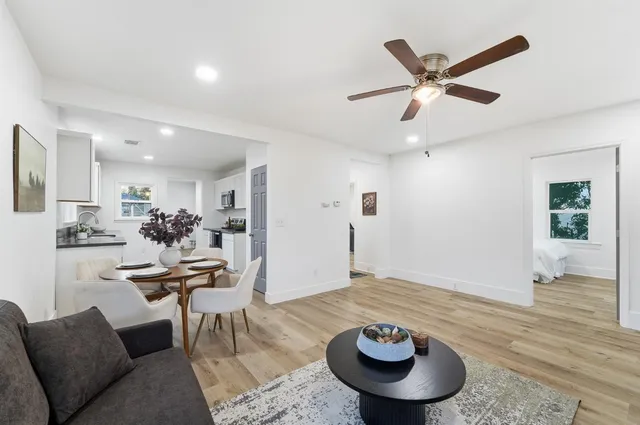 a living room with furniture and a view of kitchen